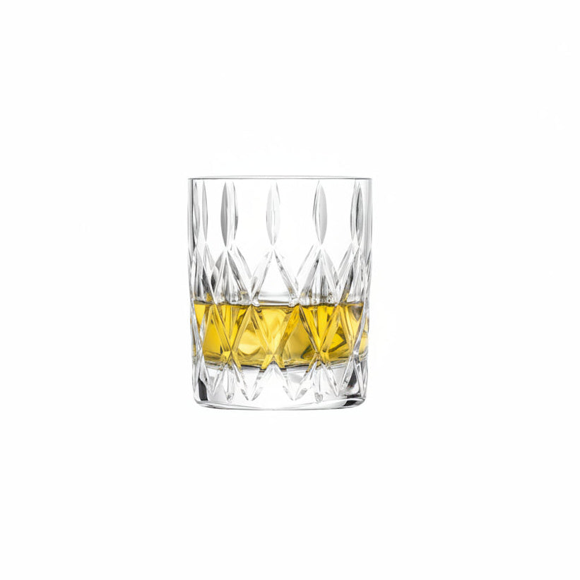 low ball glass with cut design partially filled with whiskey