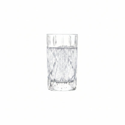 drinking glass with cut diamond design filled with a clear, sparkling beverage