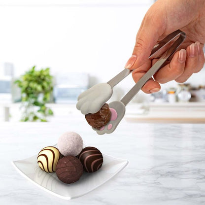 hands use cat paw tongs to pick up candies