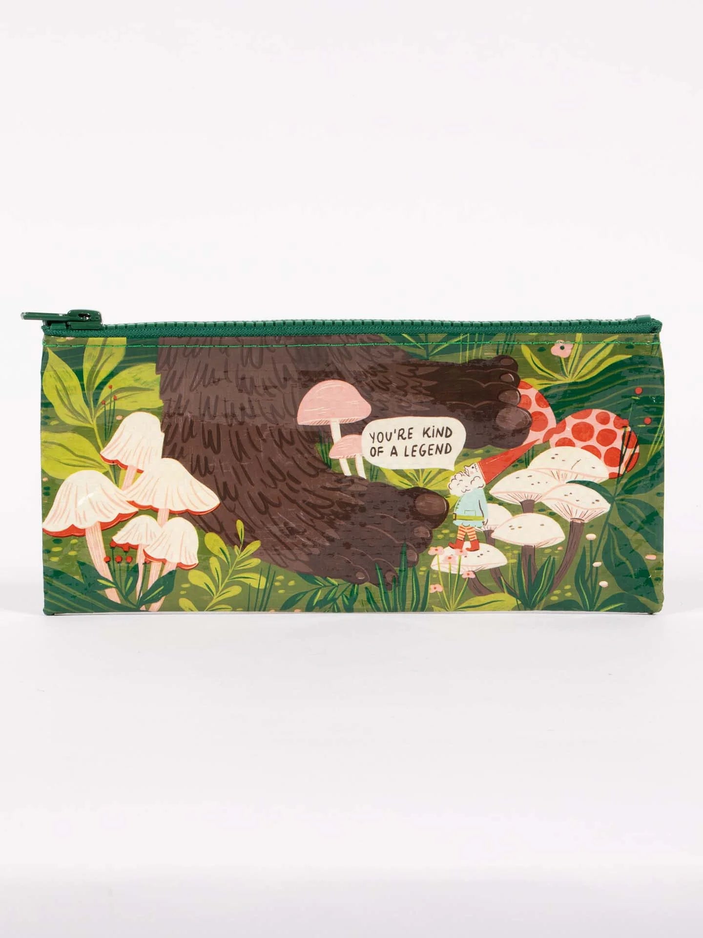 zipper bag with image of a gnome standing in grass and mushrooms looking up at a giant.