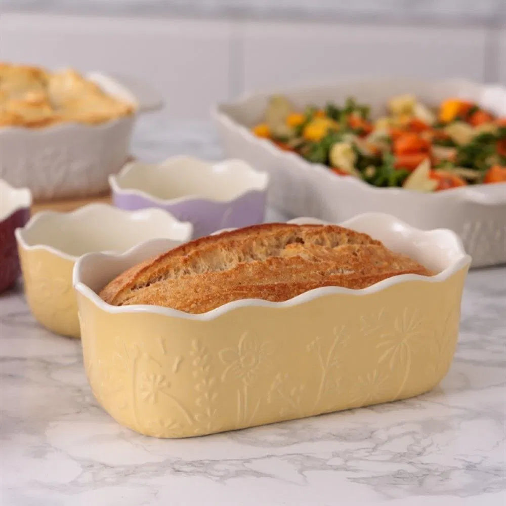 baked bread in ceramic yellow loaf pan