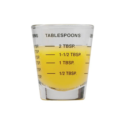 Mini Measuring Glass partially filled with liquid showing tablespoon measurements