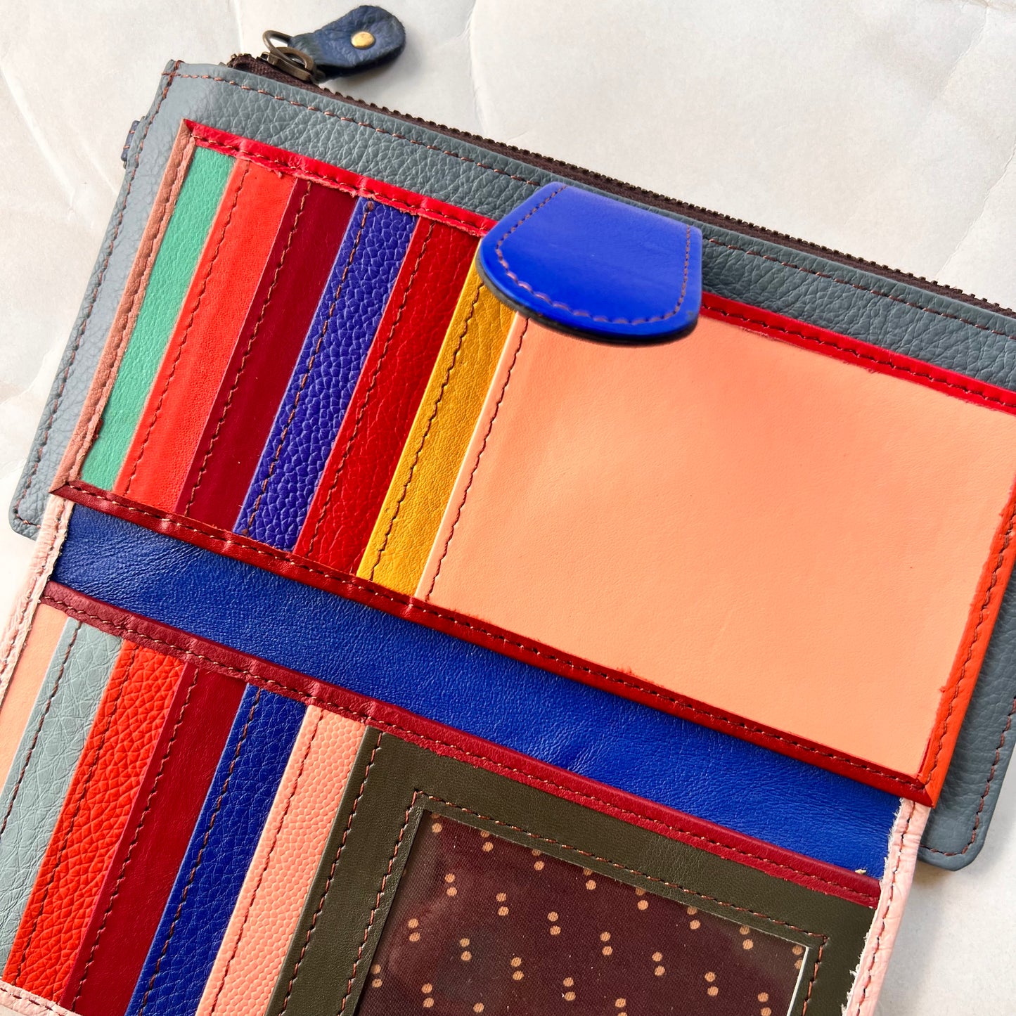 interior view of kimber wallet showing colorful card slots, pockets, and clear spot for ID.