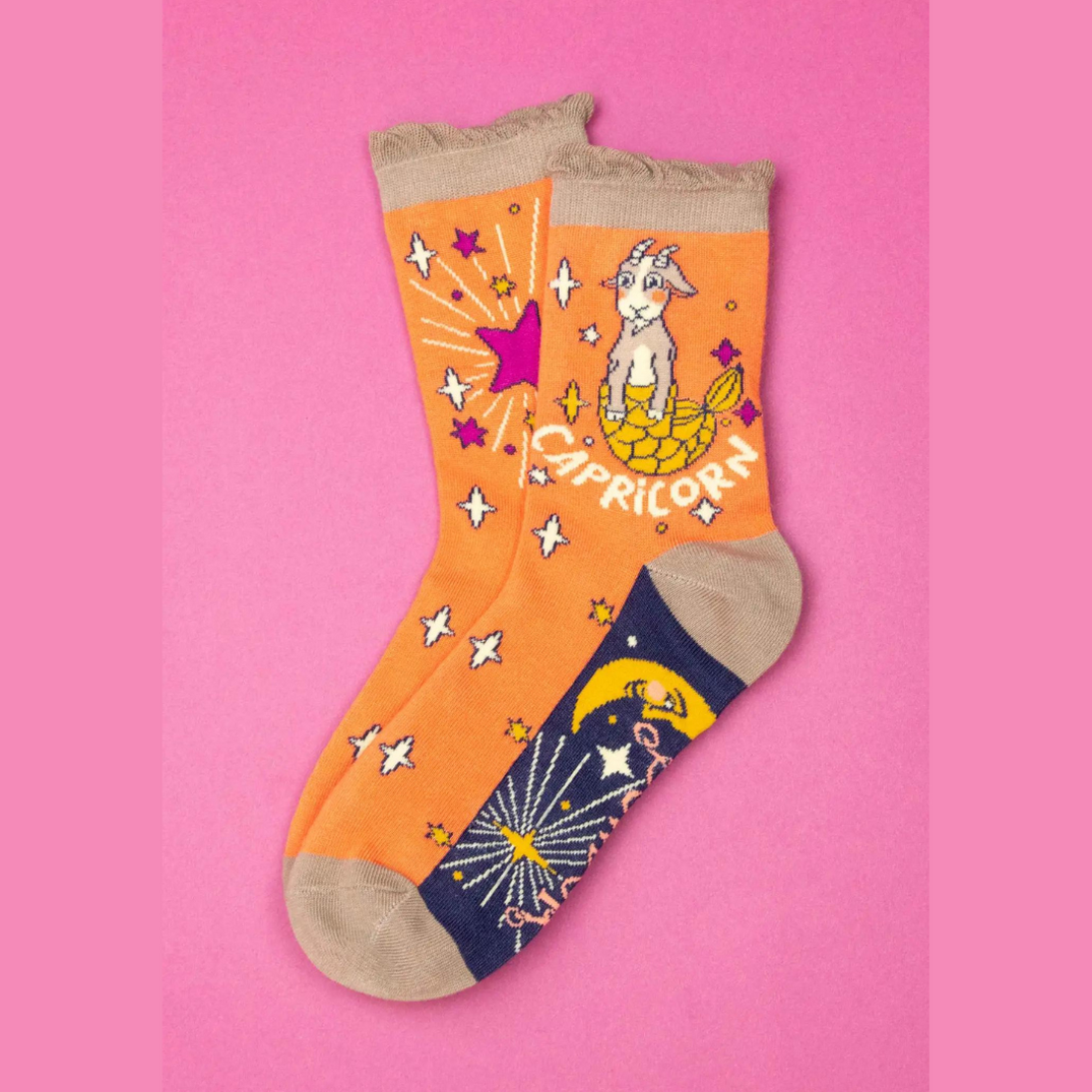 orange Capricorn socks with goat design.