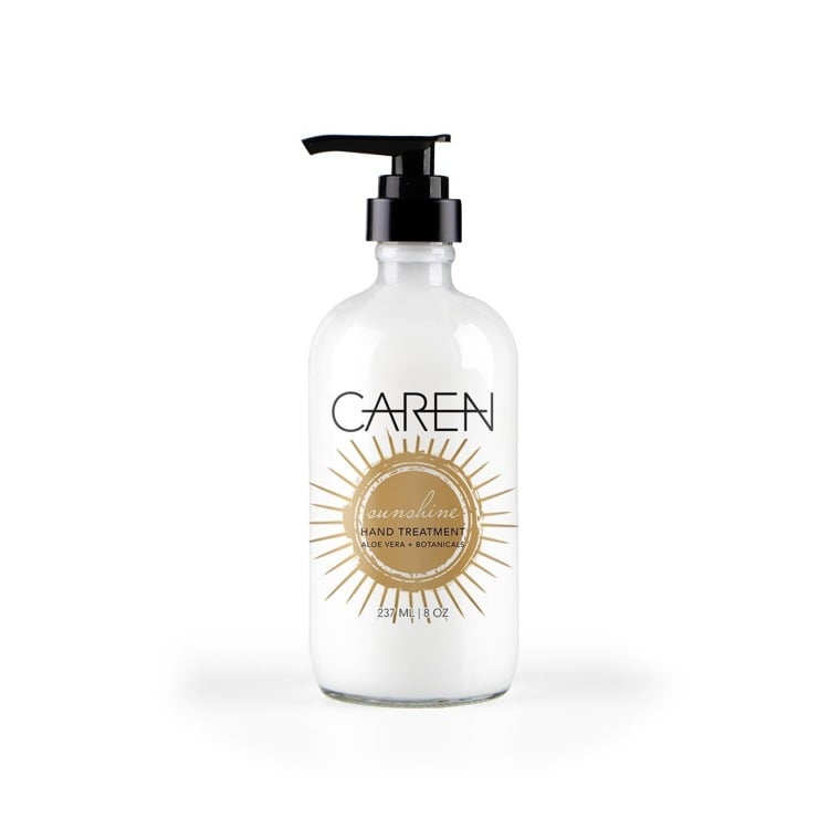 glass bottle of sunshine hand treatment with a black pump