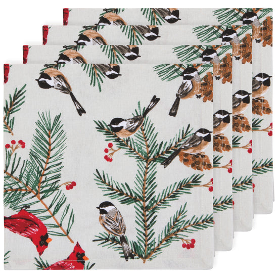 A set of four cloth napkins with a Christmas design featuring birds perched on boughs with berries and greenery against a white background.