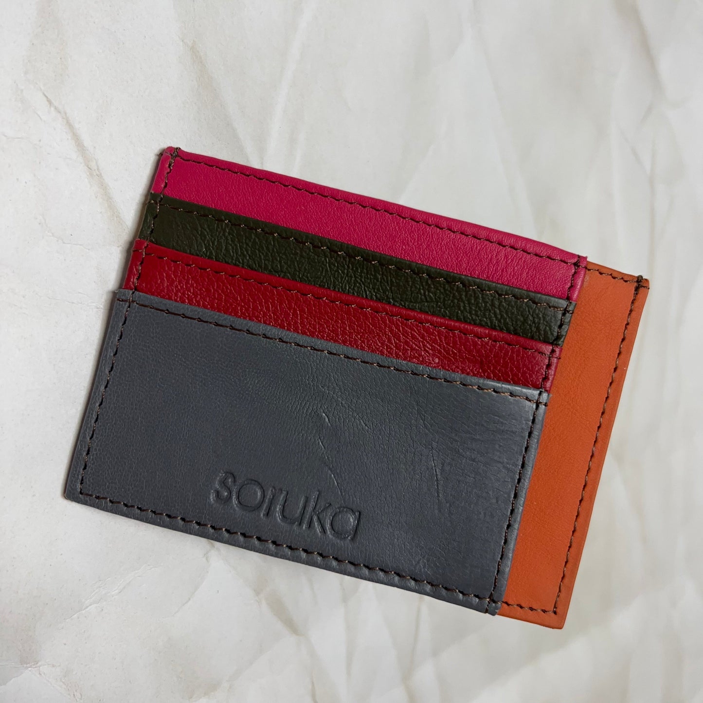 grey polly wallet with colorful card slots.