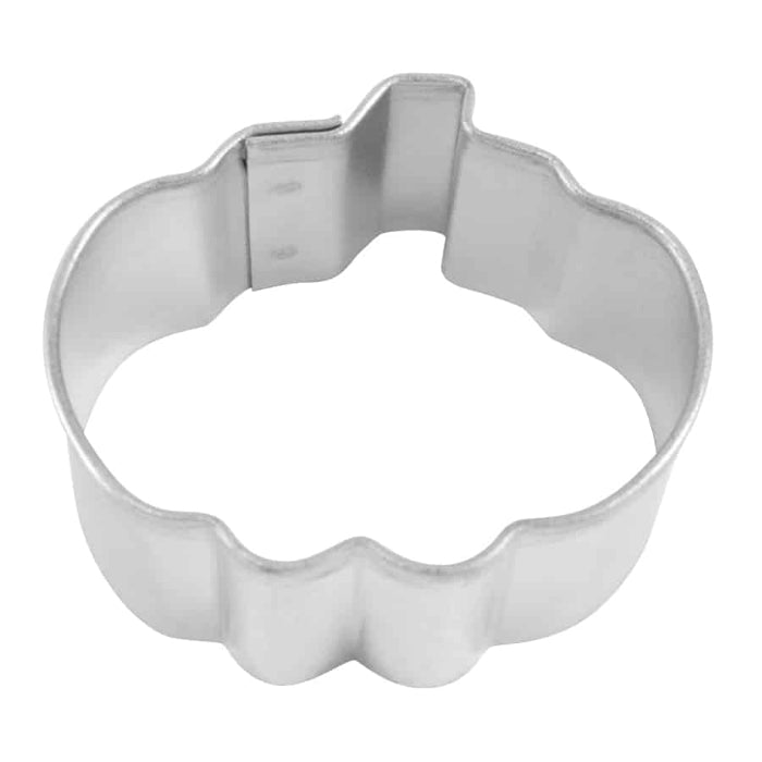 Metallic cookie cutter shaped like a pumpkin on a white background