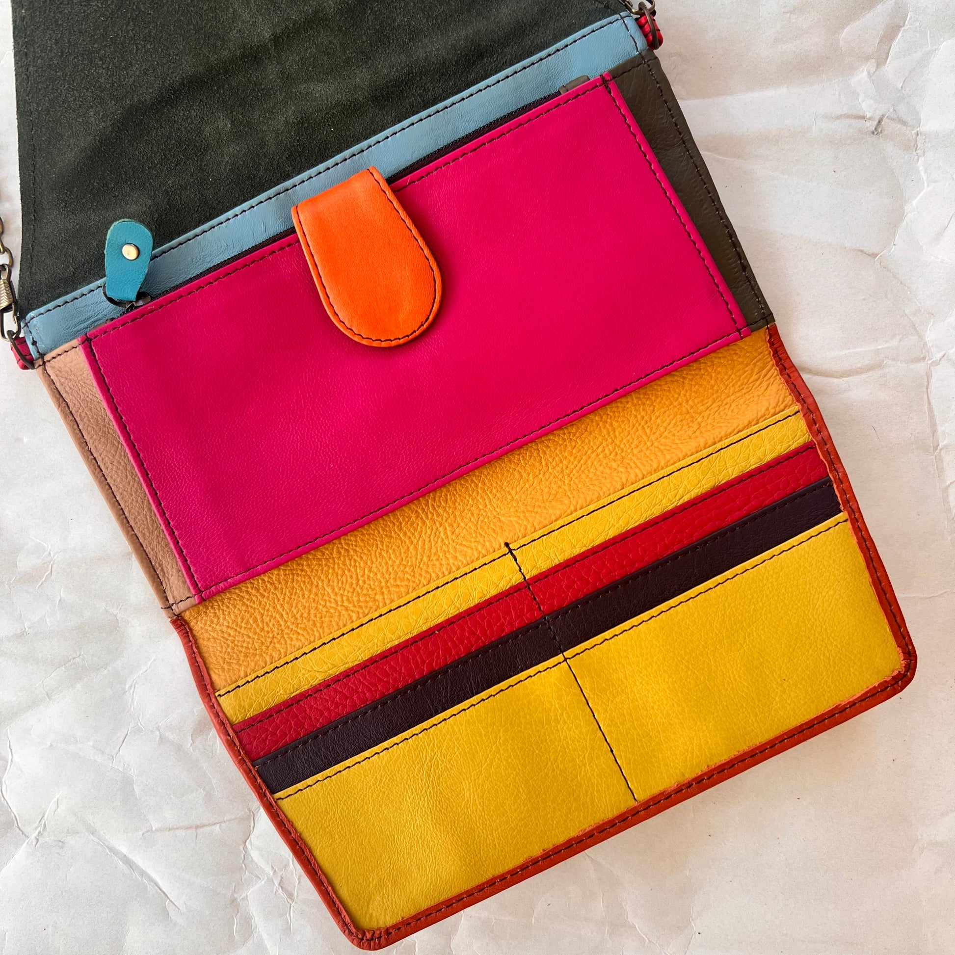 interior view of secret clutch wallet showing colorful card slots and other pockets.