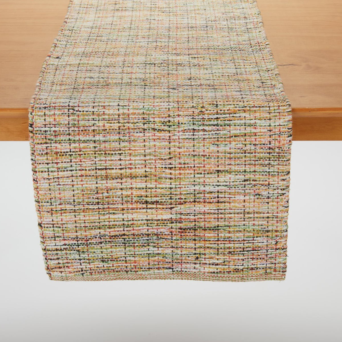 Harrisons Table Runner draped over a wooden table