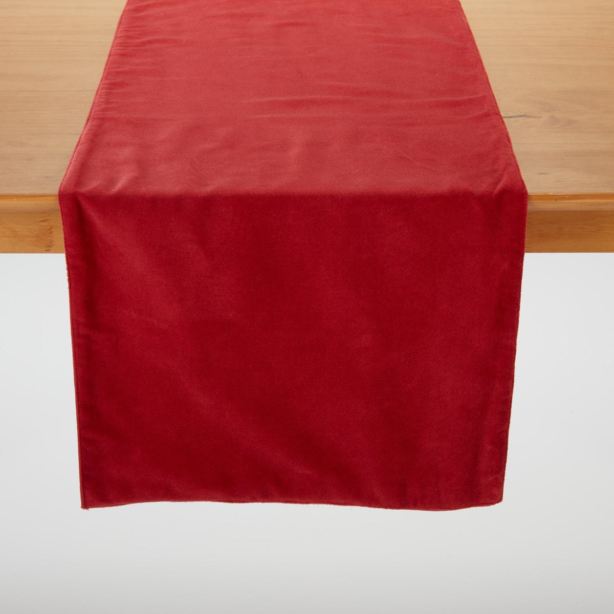 Red Velvet Table Runner draped over a wood table
