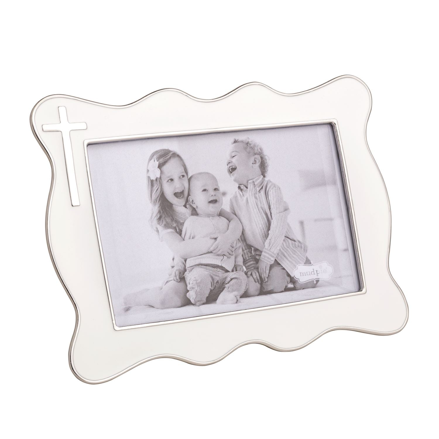 White decorative photo frame with silver cross on it and a family photo inside on a white background