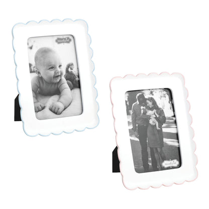 Two decorative photo frames with black and white photos of a baby and a couple.