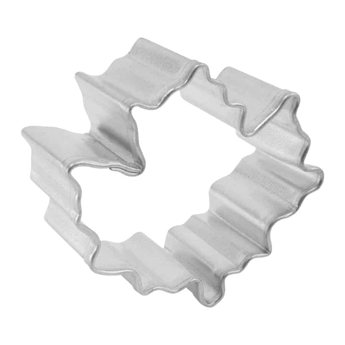 angled view of Metallic cookie cutter with maple leaf shape on a white background