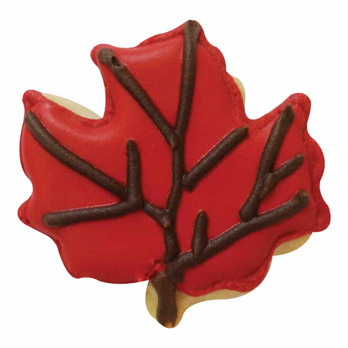 Red leaf-shaped cookie with brown accents on a white background