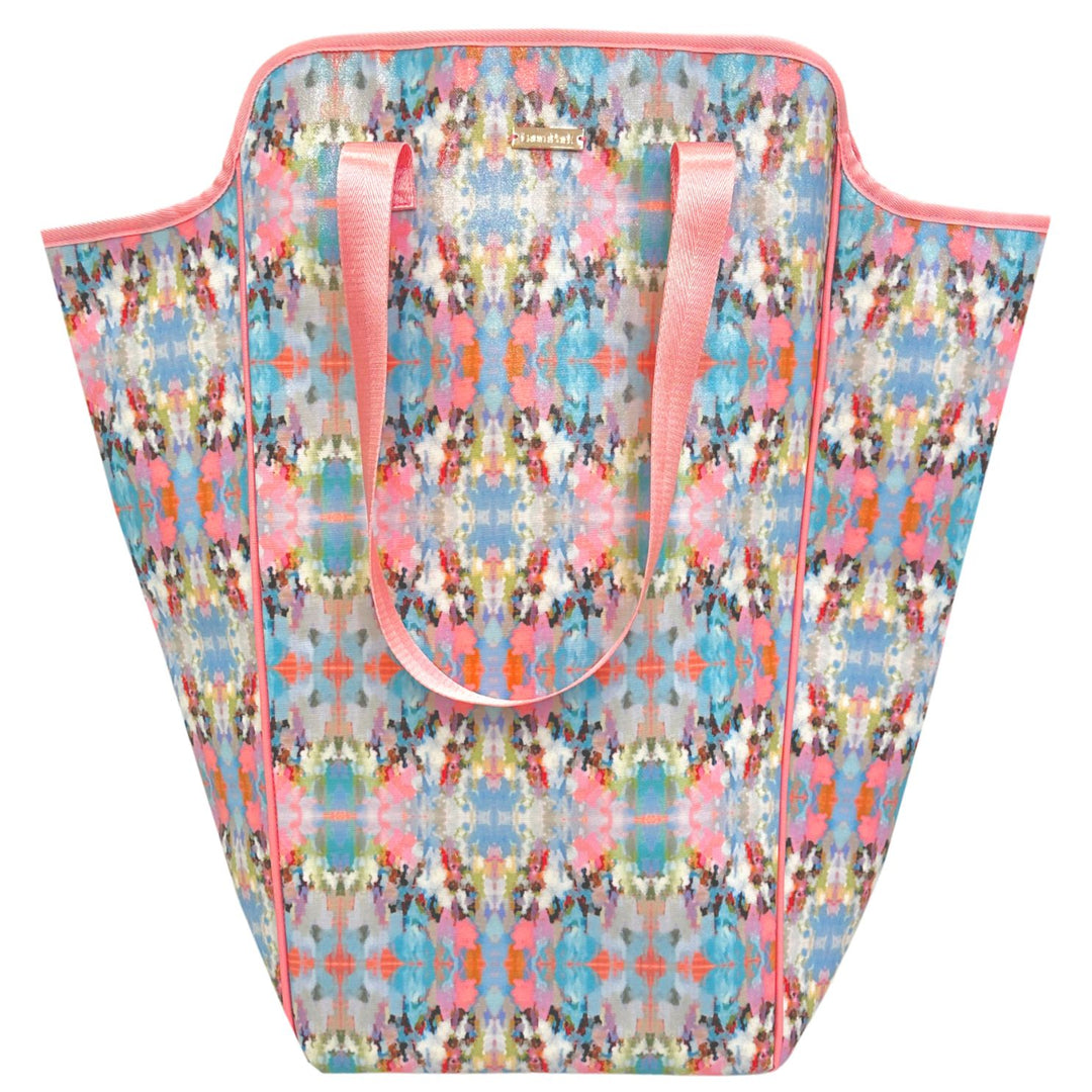 Colorful patterned laundry bag with pink handles on a white background