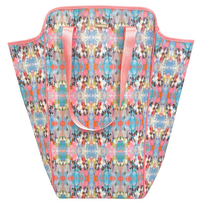 Colorful patterned laundry bag with pink handles on a white background