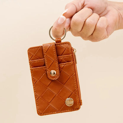 hand holding cognac wallet by the keyring.