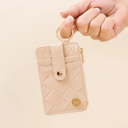 hand holding oat wallet by the keyring.