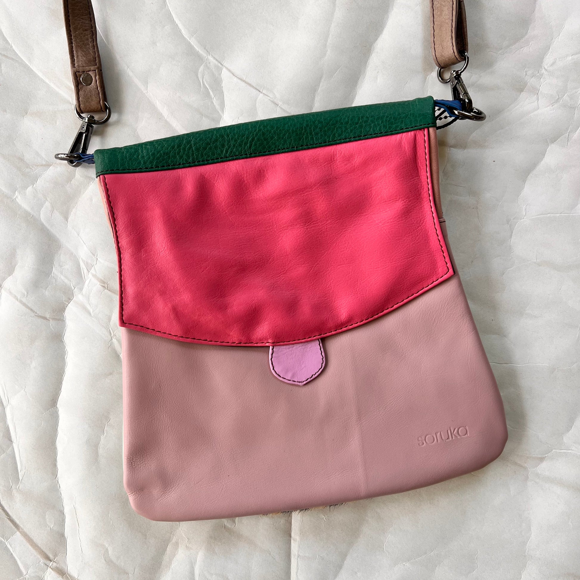 greta bag with pink flap over lilac body.