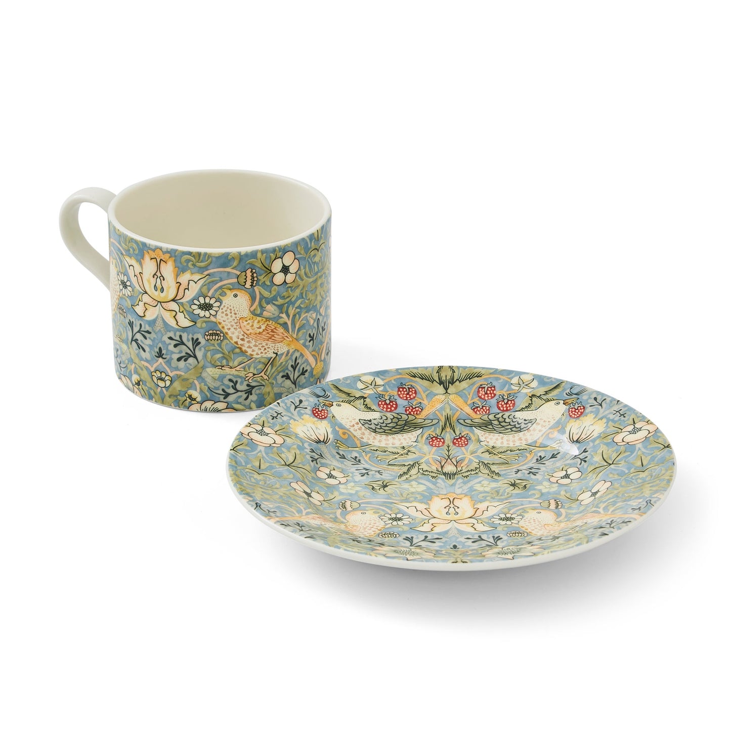 strawberry teacup next to its saucer on a white background