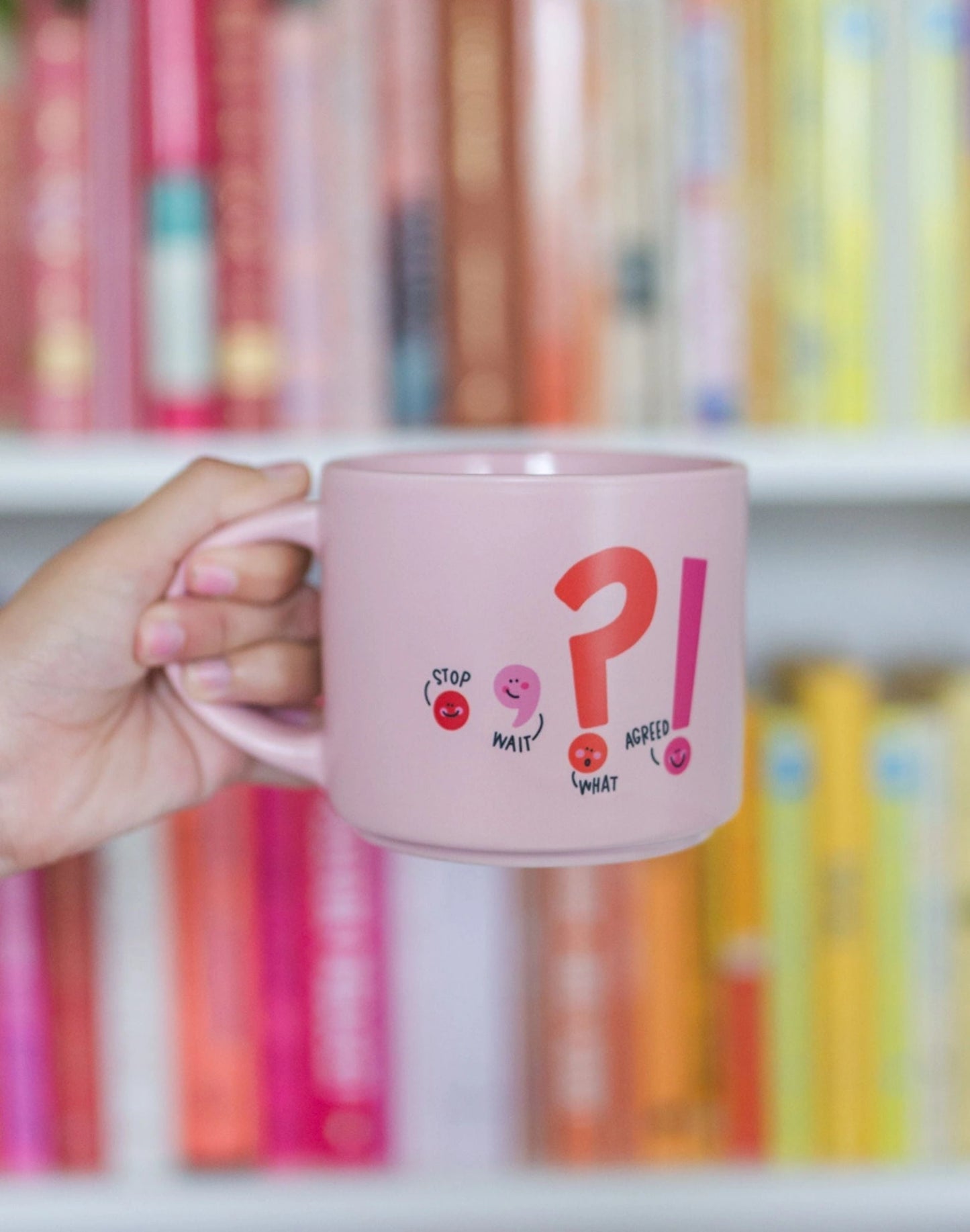 person holding the punctuation mug