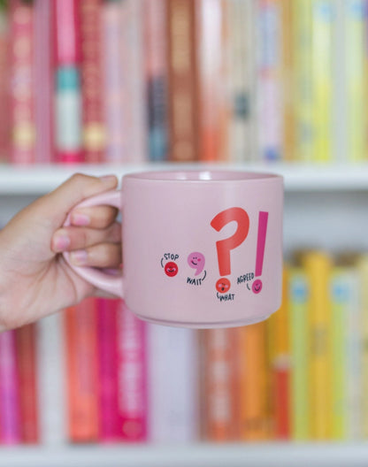 person holding the punctuation mug