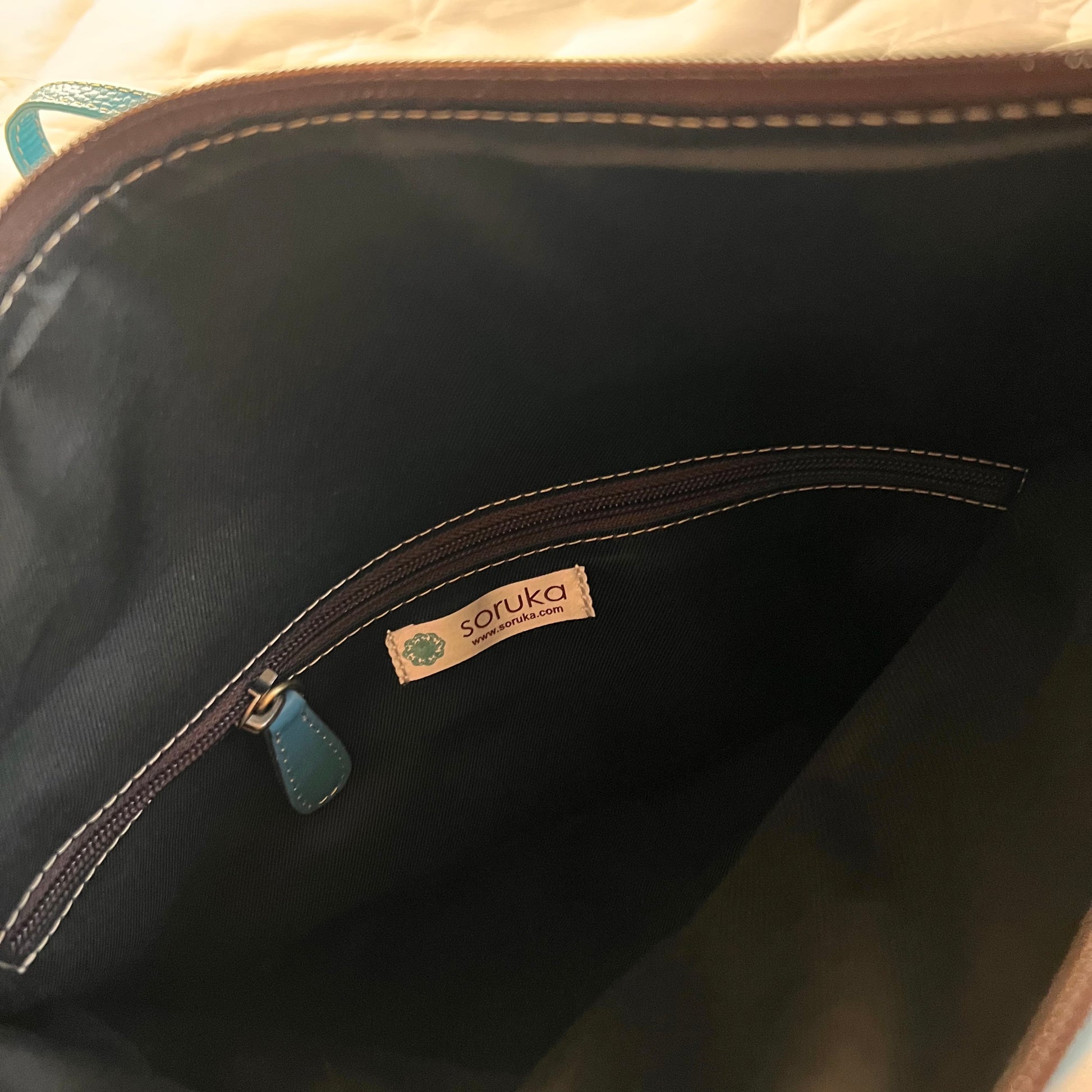 close-up of interior of mila purse showing zipper pocket inside.