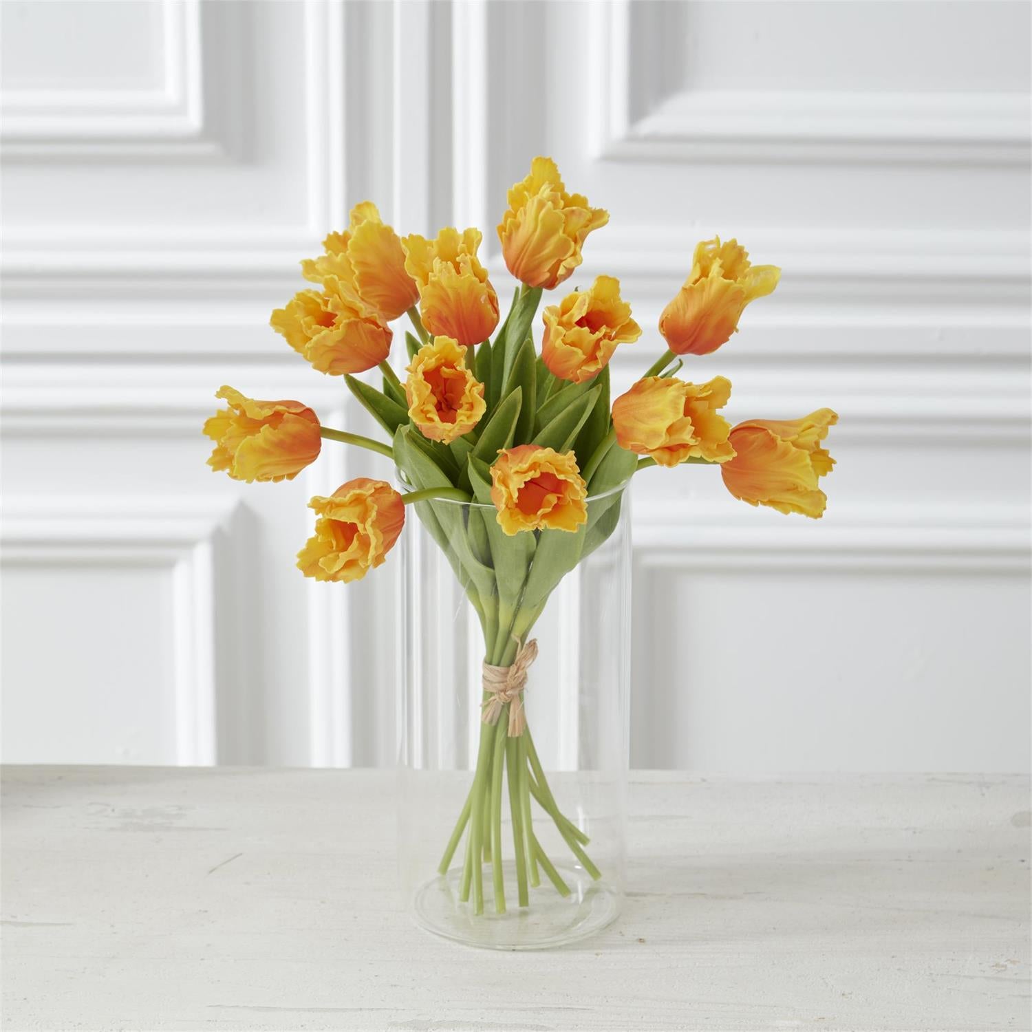 light orange parrot tulips in a glass vase