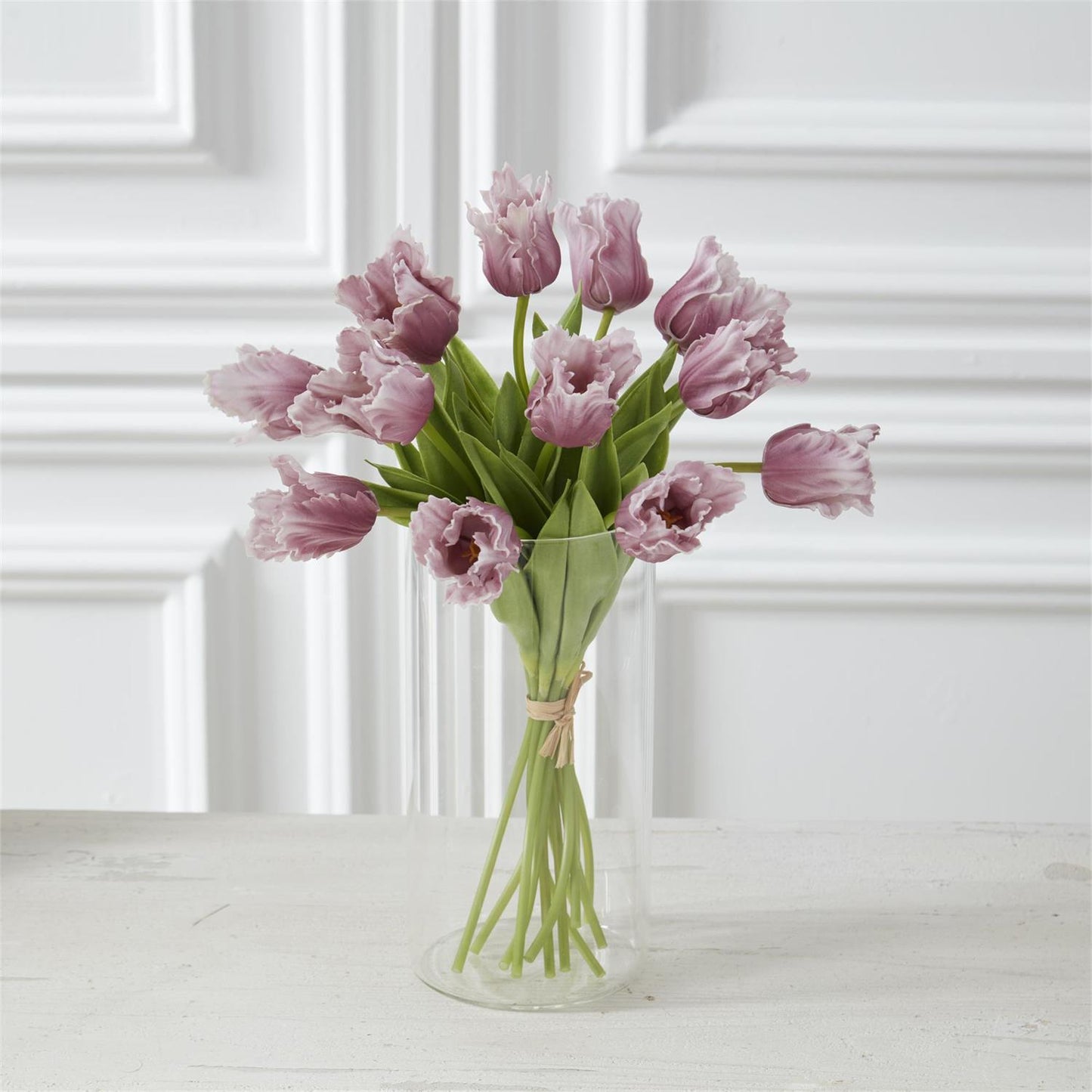 purple parrot tulips in a a glass vase