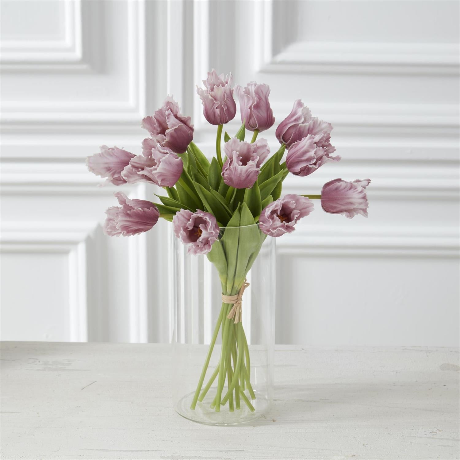 purple parrot tulips in a a glass vase