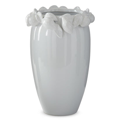 white ceramic vase with white ceramic lemons on the rim