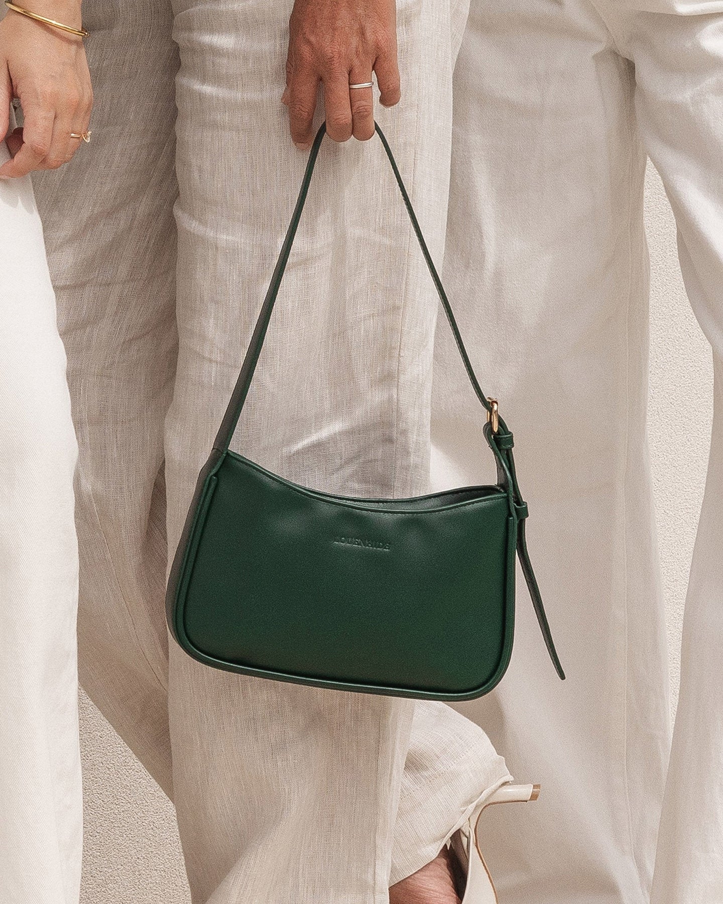 view of woman holding forest green Ivy Shoulder Bag