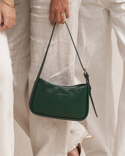 view of woman holding forest green Ivy Shoulder Bag