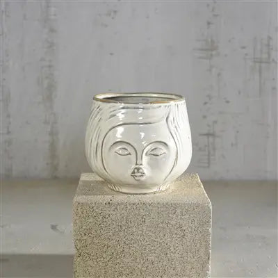 Pucker Up Vase set on a concrete pedestal on a grey background