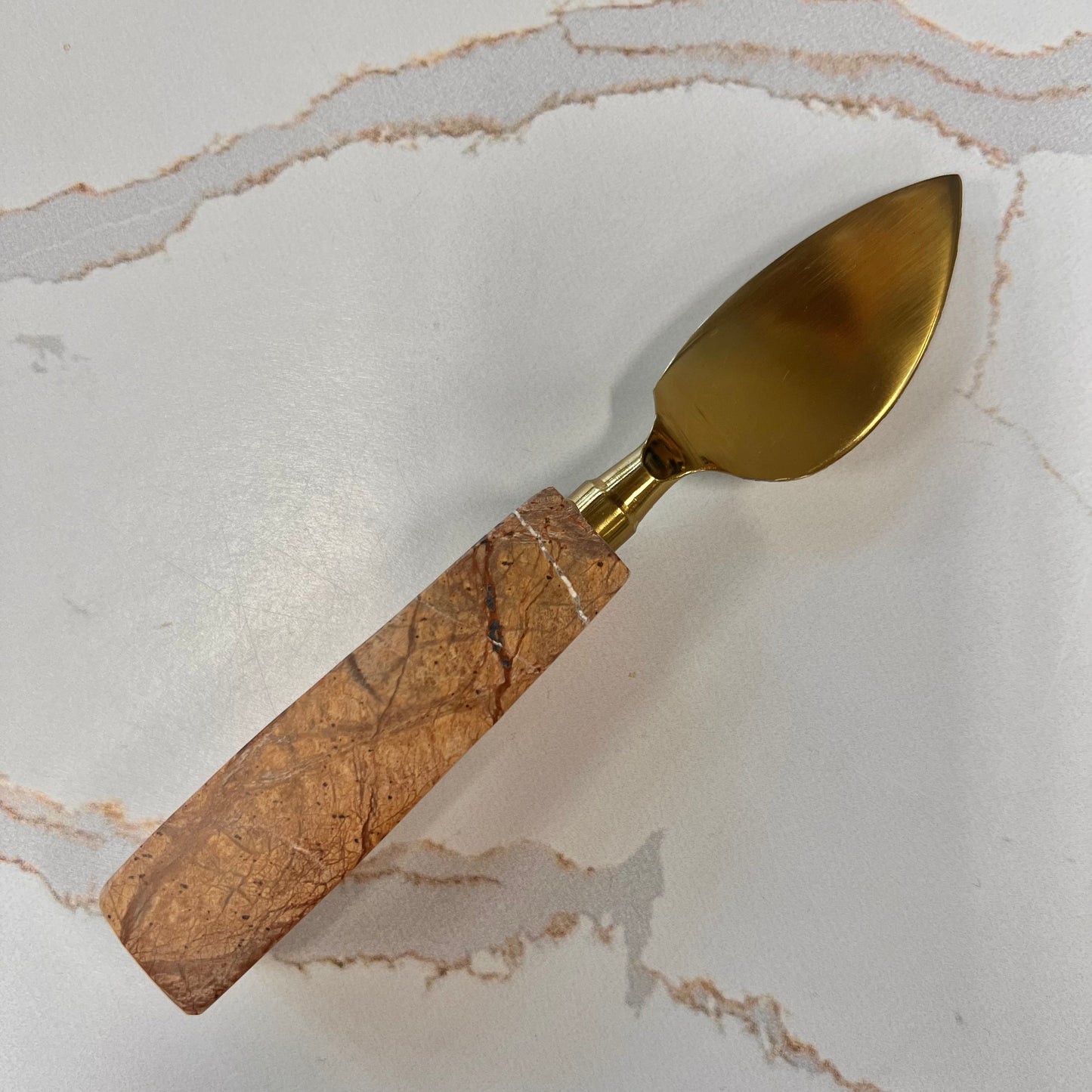 brown handled travertine curved blade cheese tool.