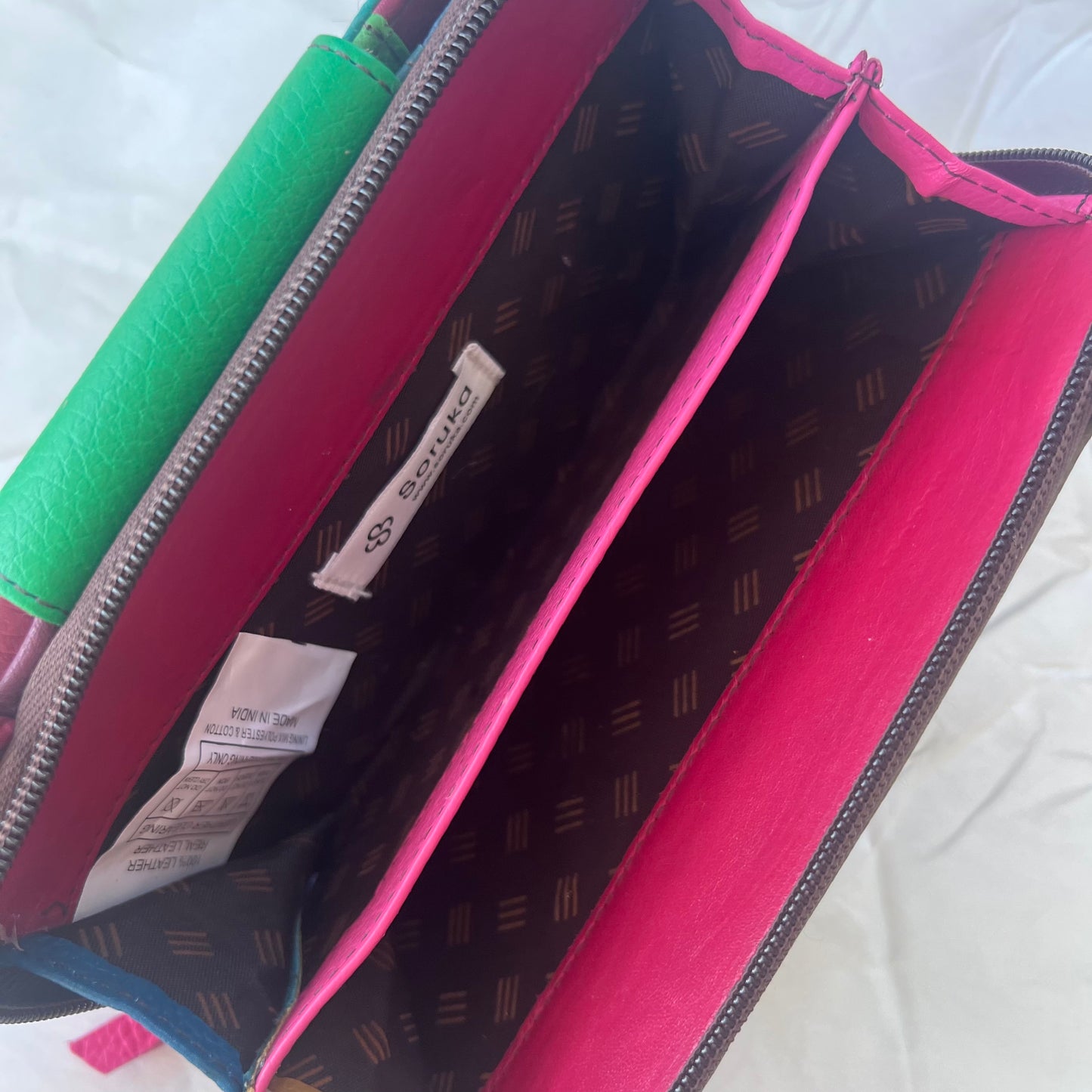 interior view of green Beatrice Clutch zippered compartment