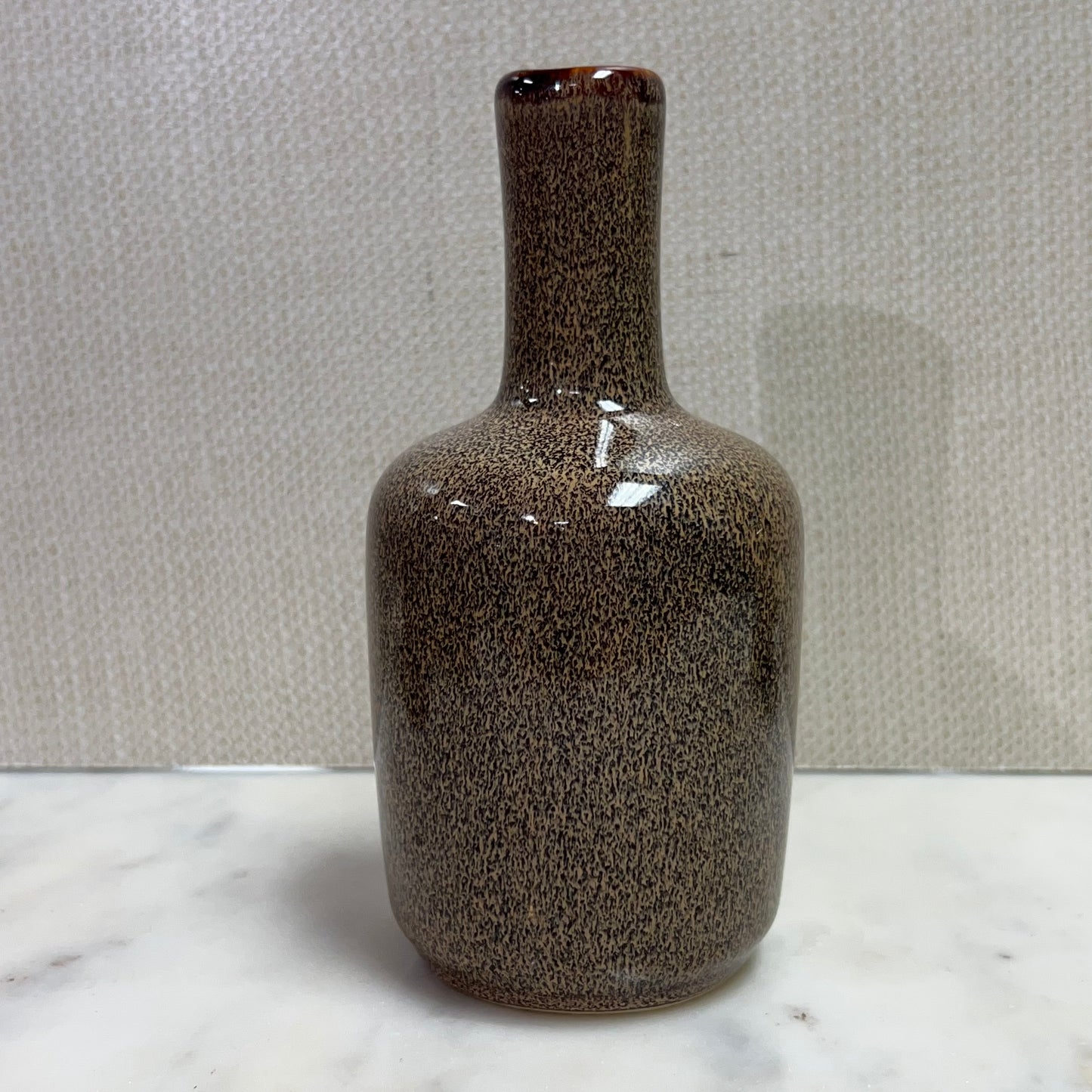 tall dark brown vase with slim neck.