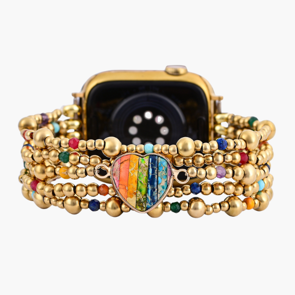 Gold beaded bracelet with a colorful heart charm on an Apple Watch