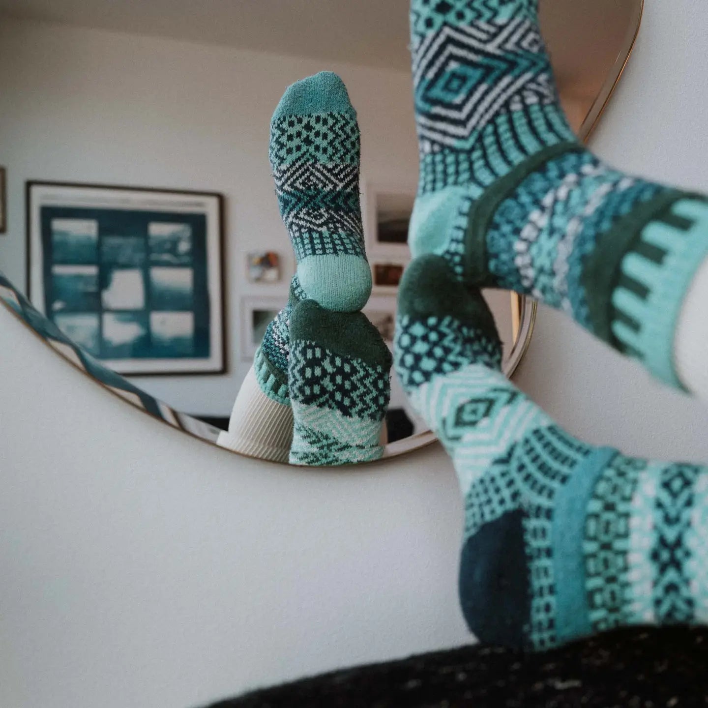 person wearing Evergreen Crew Socks with their feet up in front of a mirror