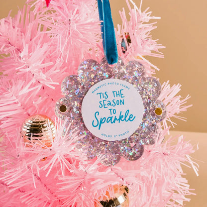 silver glitter Scalloped Acrylic Frame Ornament hanging from a blue ribbon in a pink tinsel tree