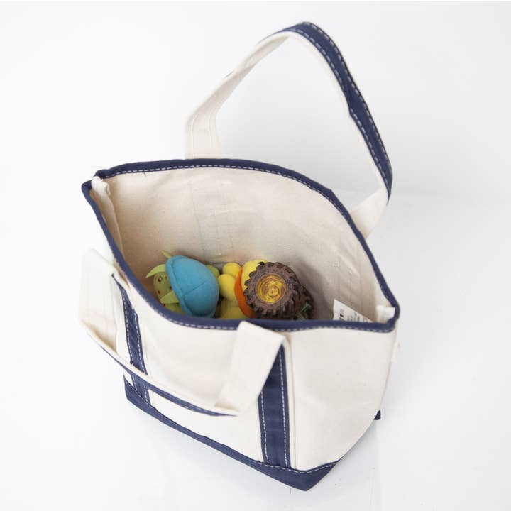 interior view of off white tote with navy handles and trim showing contents inside