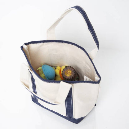 interior view of off white tote with navy handles and trim showing contents inside