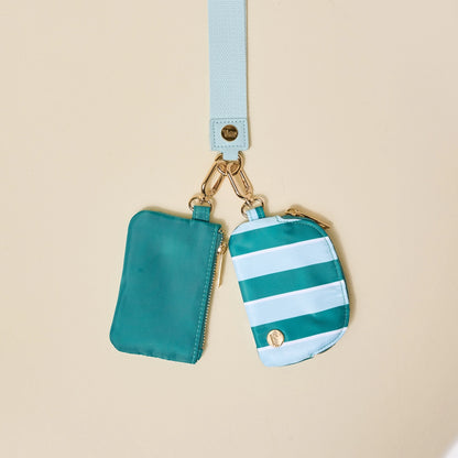 Two small pouches with a strap on a beige background