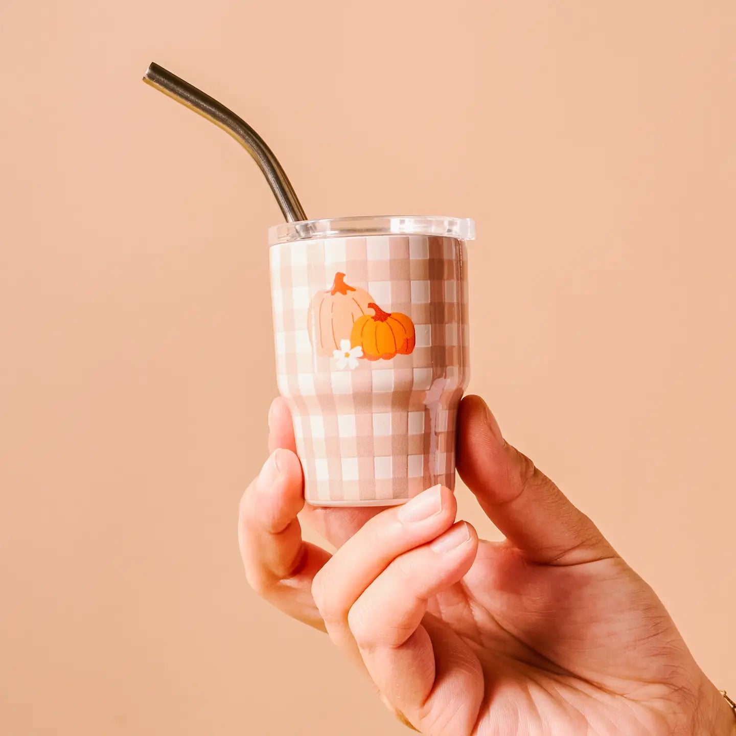 hand holding Pumpkin Gingham tiny tumbler