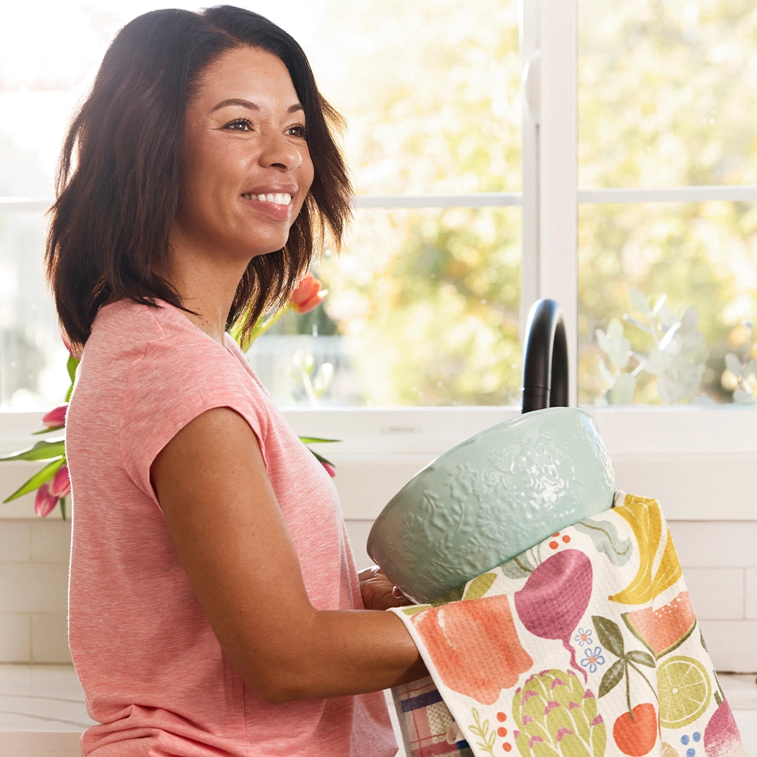 Person using farm stand dish towel to dry a large ceramic mixing bowl.