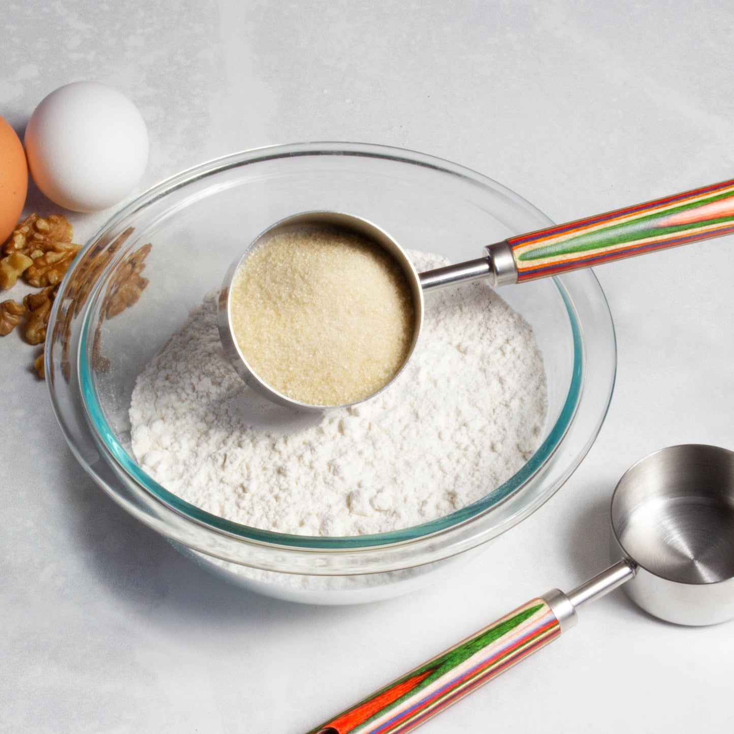 marrakesh measuring cup filled with dry ingredients of a bowl.