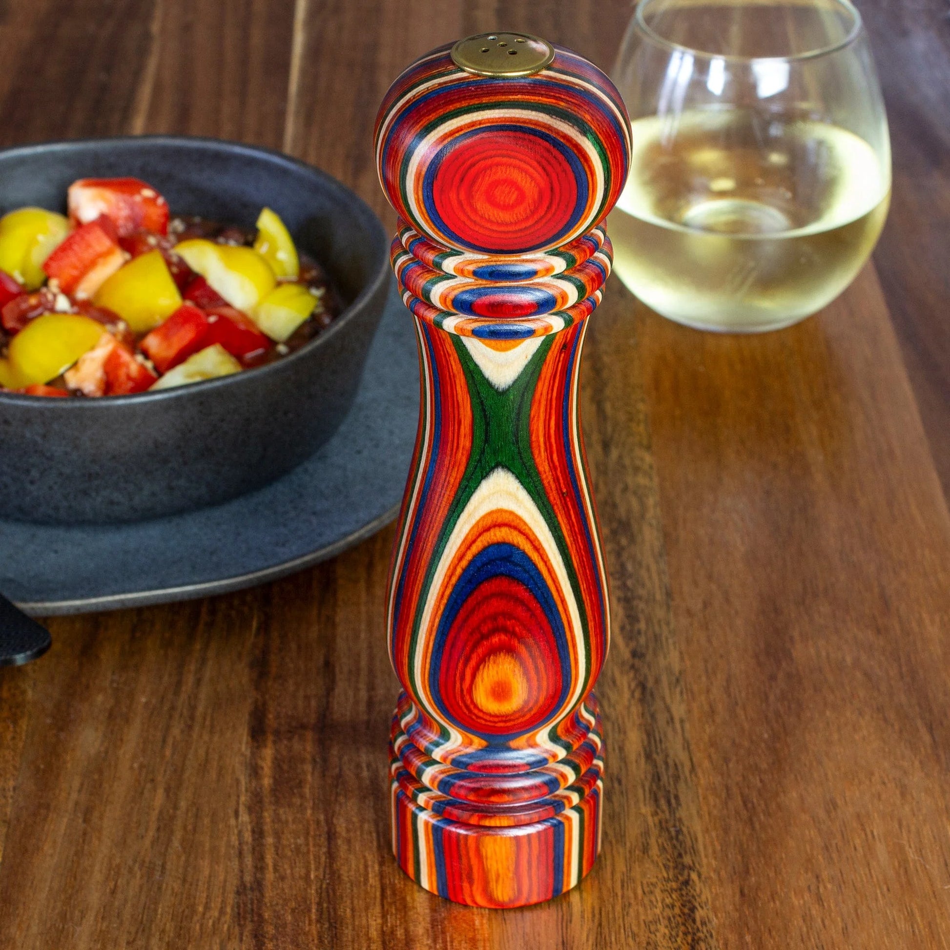 Marrakesh salt shaker set on a table with food and a drink.