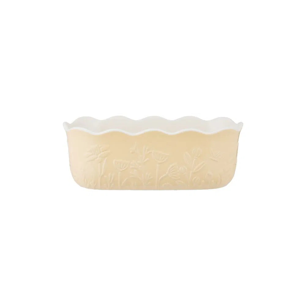 ceramic yellow loaf pan shown on a white background