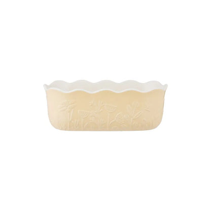 ceramic yellow loaf pan shown on a white background